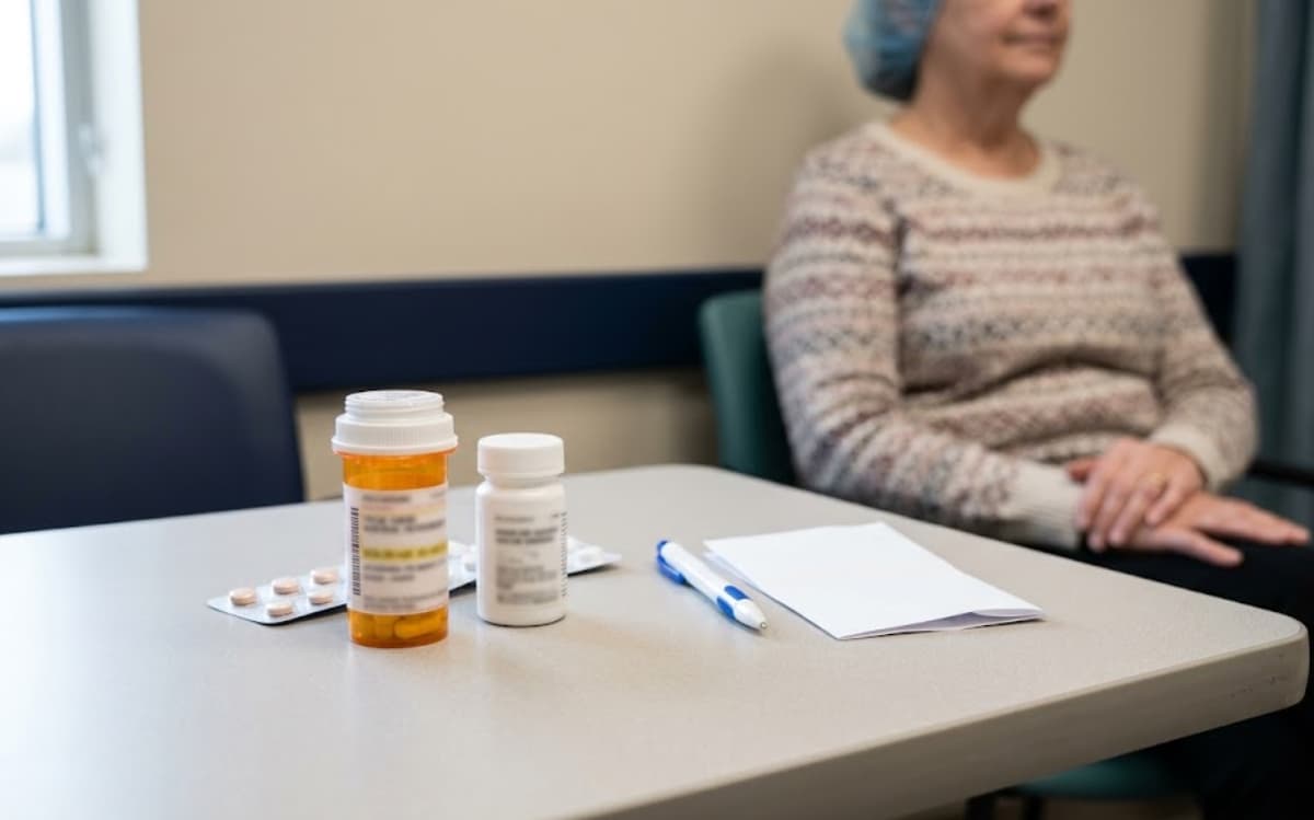 Prescription medication bottles with amber caps neatly arranged on a consultation table.